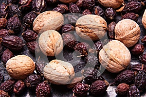 Pile of dried rose hips and Walnuts . Country house style. Authentically