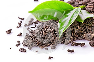 Pile of dried tea leaves and green tea leaf on top isolated on white background