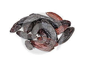 Pile of dried tonka beans closeup on white