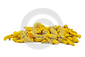 Pile of dried turmeric rhizomes on a white