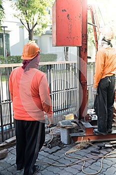 Pile driver works to set precast concrete piles