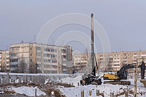 Pile driving machine in construction site .