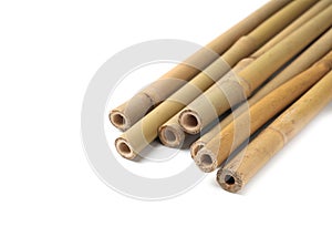 Pile of dry bamboo sticks on white background