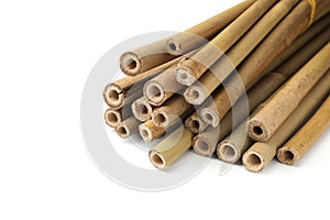 Pile of dry bamboo sticks on white background, closeup