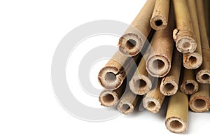 Pile of dry bamboo sticks on white background, closeup