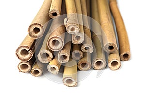 Pile of dry bamboo sticks on white background, closeup