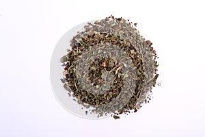 Pile of dry basil. Top view of a portion herbs seasoning isolated