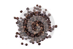 A pile of a dry black pepper seeds isolated on white