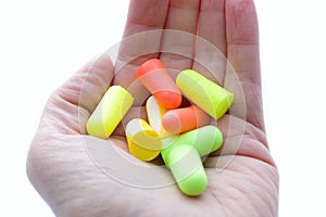 Pile of earplugs against noise in different colors in palm