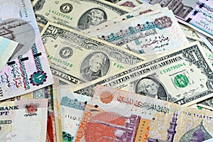 Pile of Egyptian and American money currency banknotes of 1, 2 and 20 dollars and 10, 20, 100 and 200 EGP LE Egyptian pounds bills