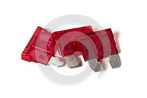 Pile of electrical automotive car fuses isolated on white background.
