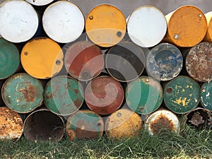 A pile of empty big rusty fuel metal barrels