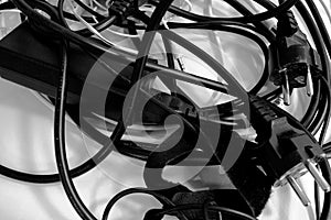 A pile of entangled cords in black and white