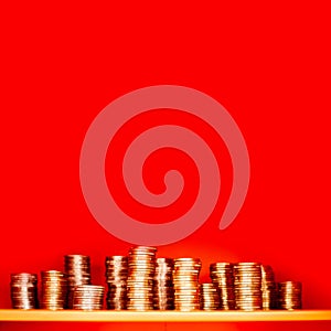 Pile of euro golden coins on red background