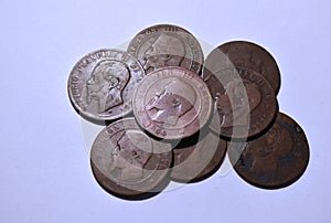 Cenital view of a pile of european coins from the eighteenth century with white background