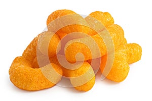 Pile of extruded cheese puffs isolated on white