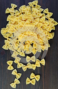 Pile of Farfalle Pasta Also Known As Bow-tie Pasta on Wooden Background