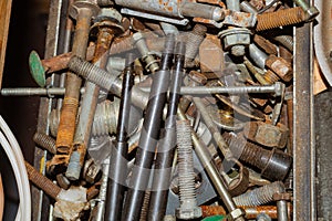 Pile of fasteners and screws close up. scrap metal. different metal parts