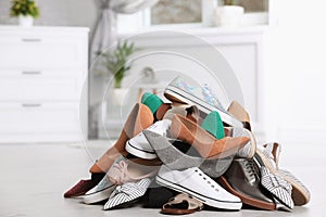 Pile of female shoes on floor
