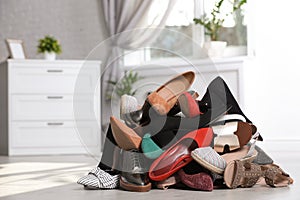 Pile of female shoes on floor