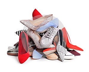 Pile of female shoes on white