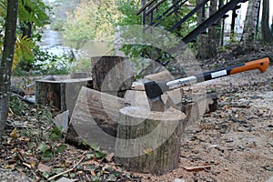 pile of firewood ax cleaver in a log