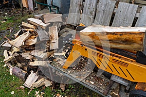 pile of firewood with a log splitter in the garden