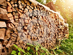 Pile of firewood for stove or fireplace. Traditional material to keep house warm. Alternative heating source. Winter preparation