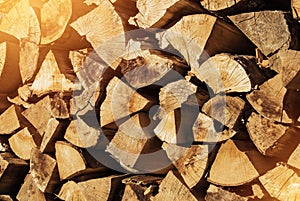 Pile of firewood toned texture background. Preparation of firewood for the winter for cooking, kindling of a fireplace. Stacks