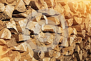 Pile of firewood toned texture background. Preparation of firewood for the winter for cooking, kindling of a fireplace. Stacks