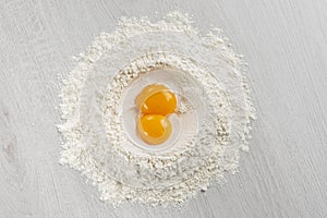 Pile of flour with egg yolks