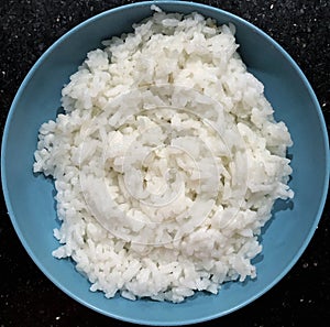 a pile of fluffy white rice in a blue plate