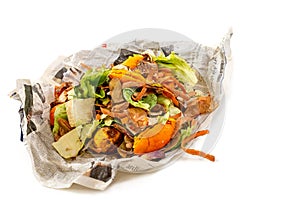 A pile of food waste, such as eggshells and fruit and vegetable peels, on a newspaper white background photo