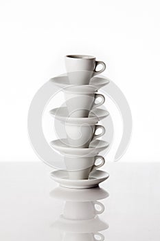 Pile of four white coffee cups photo