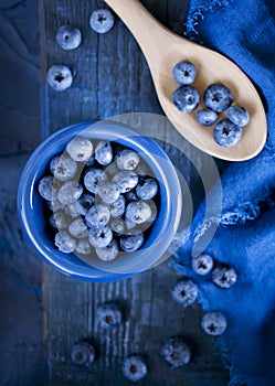 Pile of fresh blueberries on wooden spoon