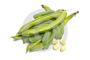 Pile of fresh green ripe bread beans copy space close up isolate