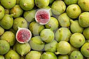 Pile of fresh, honey sweet, green figs, one cut open