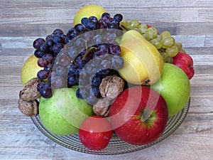 A pile of fresh organic autumn fruit on bleached  oak wood background. Healthy diet / fruit / food. Orchard crop / production / ha