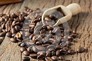 Pile of Fresh Raw Coffee Beans on Wooden Desk Table