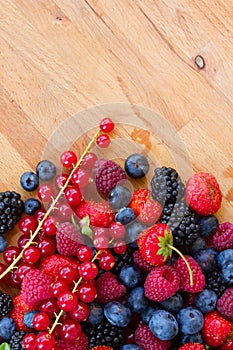 Pile of fresh red and blue berries on table