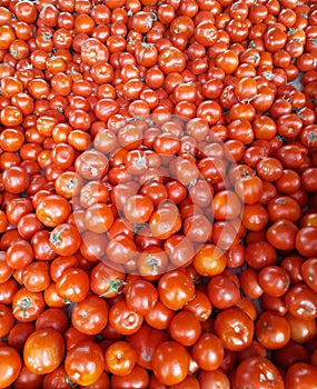 Pile of fresh red ripe delicious tomatoes in a market for sale