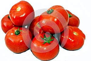 Pile of fresh red tomatoes vegetables isolated on white background, selective focus of fresh raw organic tomato, healthy food