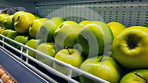 a pile of fresh and ripe green apples stored for sale