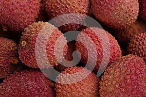 Pile of fresh ripe lychees as background, top view