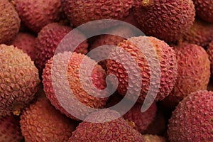 Pile of fresh ripe lychees as background, top view