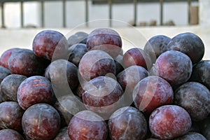 Pile of Fresh Ripe Organic Red Plum Fruits For Sale at the Local Market, Texture background