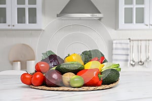 Pile of fresh ripe vegetables and fruits on table in kitchen