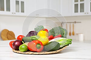 Pile of fresh ripe vegetables and fruits on table in kitchen