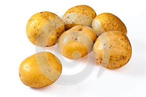 Pile of fresh, yellow, ripe potatoes, isolated on white. Close u