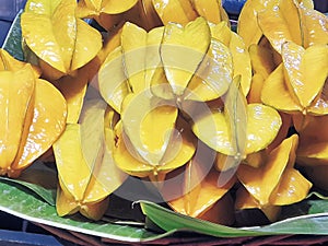 Pile of Fresh Yellow Star Fruits on Banana Leaf